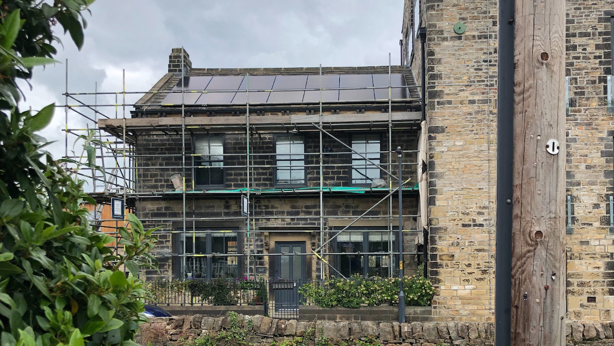 Solar Pv and Battery Storage in Cononley village near Skipton. Solar PV on to a stone slate roof.